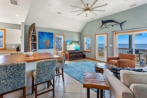 Welcome to your seaside sanctuary in the Living Area with nearby Dining Area and Kitchen.