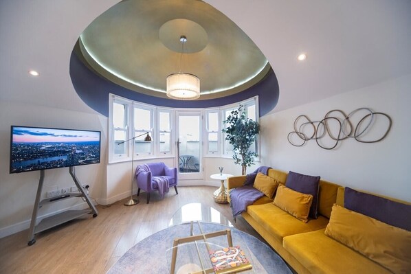 Living room, Sofa, Armchair, Smart TV, Balcony.