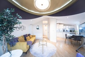 Living room, Sofa, Armchair, Smart TV, Balcony.