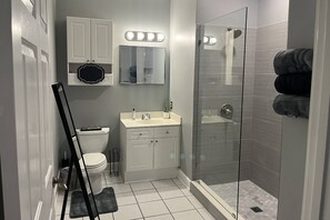 Bathroom features an updated stand-up shower and is beautifully decorated.