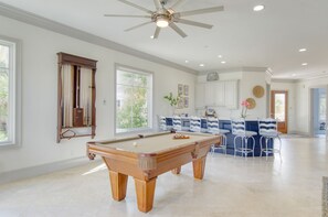 Airy secondary lounge space complete with a large bar area and a pool table.