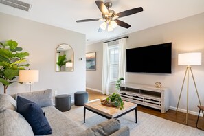 Living area features a large flat-screen TV.