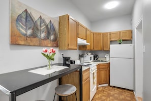 Fully stocked kitchen with all cookware, dishware and flatware needed. Plus a work from home tall table for eating and home study time.