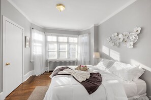 Bdrm 1 has a queen size bed, private balcony, closet space, plenty of natural sunlight and a warm comfortable energy.