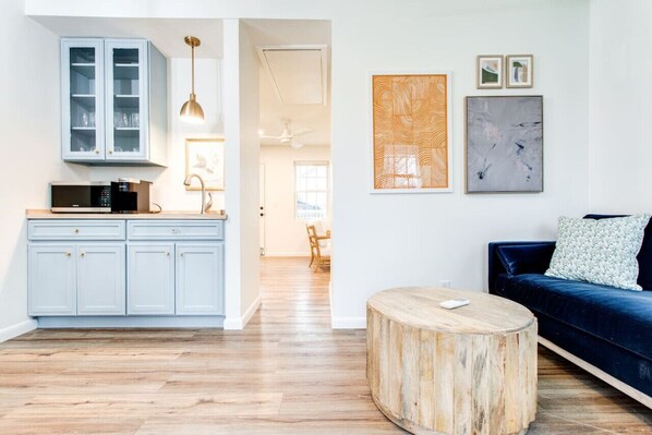 The view as you walk into the property. You step into the living room and kitchenette area. The bedroom is off the little hallway, and there is no door.