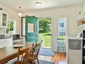Entrance, into the bright kitchen-