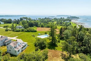 Aerial View of the cottage, pool, and shoreline-