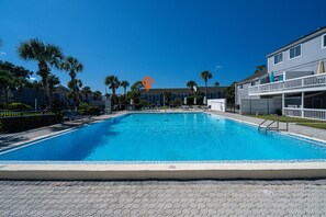 Resort swimming pool is right across from home. Poolside Paradise: Dive into relaxation at the sparkling pool surrounded by swaying palms!