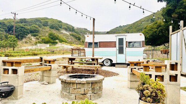 1964 Northwest Deluxe Camper, remodeled in a Southwestern feel, with an outdoor shower, firepit, picnic table and gorgeous views of the 40-acre working farm.