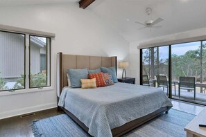 Primary bedroom with a view of Hole #12 and an inviting california king bed