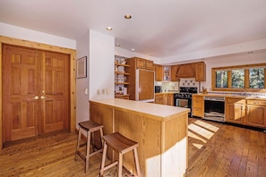 Historical Crocker Ranch - Coach House - Kitchen with a breakfast bar and two bar stools