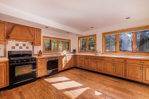 Historical Crocker Ranch - Coach House - Open kitchen with many windows lets in ample natural light.  Kitchen has a hooded gas range.