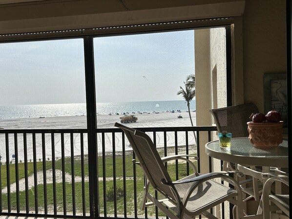 Screened Lanai w/ table and seating.. Relax and enjoy dinner & sunset al fresco!