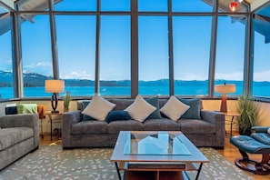 Enjoy panoramic Lake Tahoe views from the living room with floor-to-ceiling windows. Listen to the waves crash on the rocks below as you relax by the gas fireplace or watch your favorite shows on the smart TV.