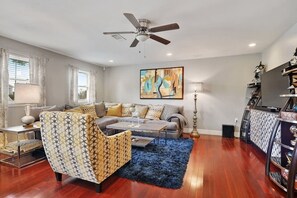Beautifully appointed family room. Large screen television. Lots of light through windows. 