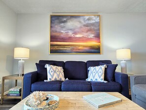 The inviting living room will be just the place to enjoy your favorite movies and sports on the 75 inch TV; spend time with friends or family,; or simply take-in  the ocean views from the large floor to ceiling glass doors.