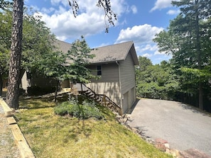 Front, side view of the home in the height of summer - garage pictured