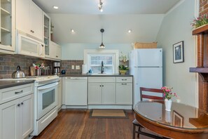 Kitchen with eat-in dining for 2, a dishwasher, and a standard drip-style coffeemaker.