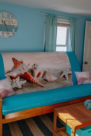 a close up shot in the living room of the queen sized futon pull down couch bed