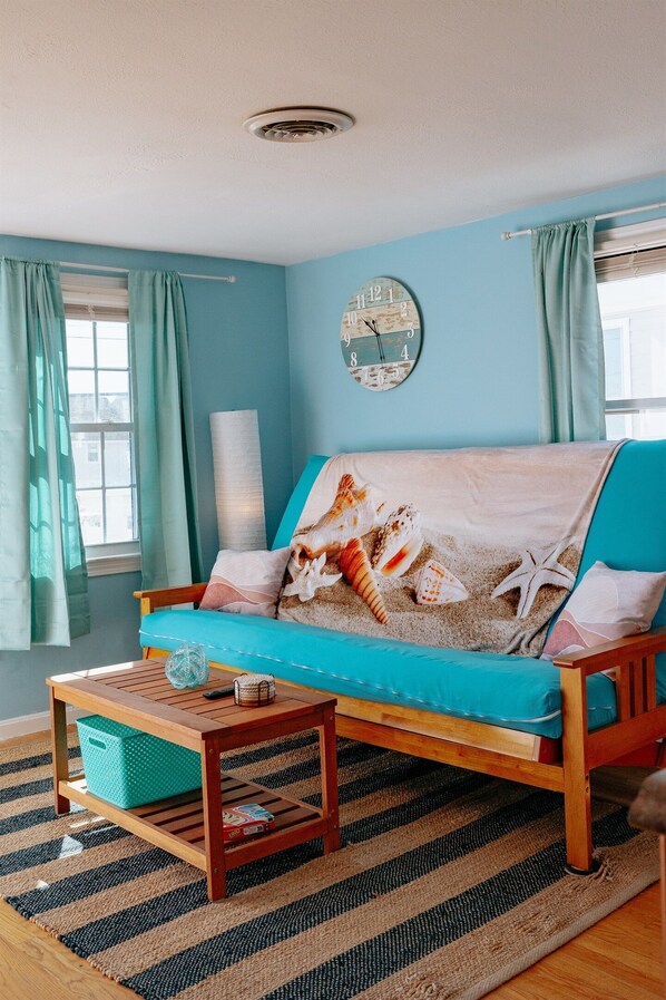 a view of the living room, complete w/queen size pull down futon couch & coffee table. This room has an air conditioner in the window during the on-season.
