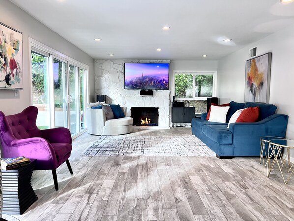 Living room area. Fireplace, 70 Inch Smart TV, Apple TV, Surround Sound.