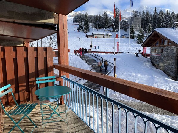 The apartment overlooks the snow front and its ski lifts.