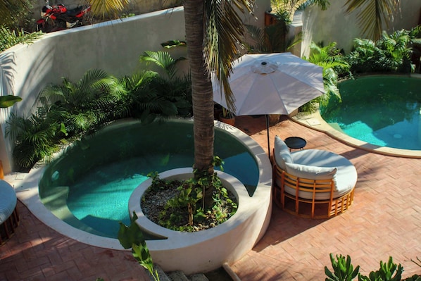 Find your perfect spot by the poolside — whether it’s lounging in the sun or relaxing in the shade, every corner offers comfort and charm.”