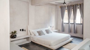 Our spacious master bedroom welcomes you with a plush king-size bed and premium bedding, promising restful nights. Enjoy the convenience of a private bathroom with a refreshing shower, plus air conditioning and ceiling vents that keep your comfort pe