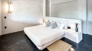 Spacious master bedroom with a king-size bed, premium bedding, private bathroom with shower, air conditioning, and ceiling vents for ultimate comfort.