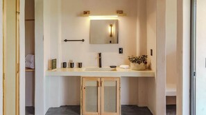 Master bathroom with a luxurious shower, fully equipped with premium amenities including shampoo, conditioner, body soap, towels.