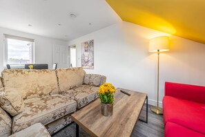 Living room with 2 sofa beds, Smart TV and dinning table.