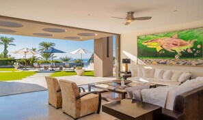 Comfortable seating area that opens to the patio, bringing in the ocean breeze.