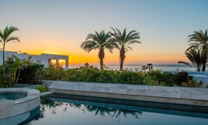 Captivating sunset views reflected in the tranquil private pool, creating a serene evening atmosphere.