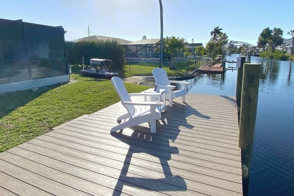 Embrace serenity by the canal. Our tranquil and harmonious private fishing dock beckons with soft ripples in the water and two inviting lounge chairs. Cast a line, unwind, and savor moments of bliss amid nature's embrace. 