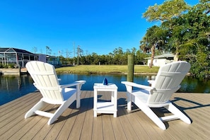 Immerse yourself in waterfront bliss. Our scenic fishing dock offers a haven of relaxation, with picturesque canal views and two cozy lounge chairs awaiting your arrival. Dive into tranquility and let the beauty of nature wash over you. 