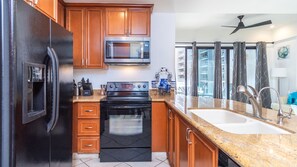 The kitchen is complete with large and small appliances, lots of cabinets and cookware as well.