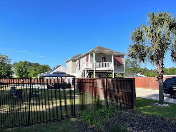 Half acre property with Pool, Gazebo, Fire Pits, Palm Tree, Fenced in yard and Large Driveway!