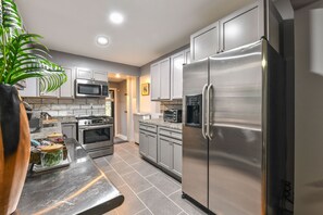 Modern recently renovated fully-stocked kitchen.