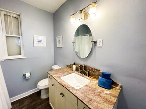 The bathroom has a shower and tub