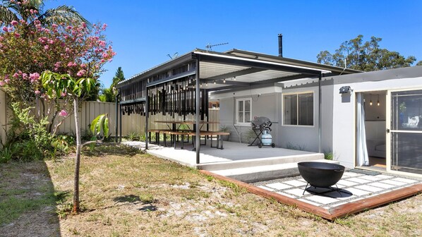 Large outdoor entertaining area with table and chairs and BBQ