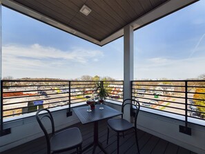 Private balcony with outdoor seating and refreshing Downtown views.