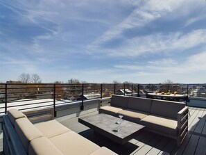 Private 4th-story balcony featuring outdoor furnishings for lounging and dining offering neighborhood and city views.