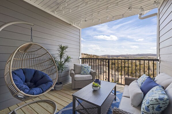 Enjoy the fantastic views at the spacious balcony with hanging egg chair!