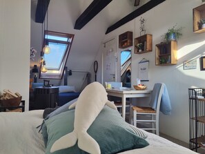 The bed room with the door, seen from the small double bed