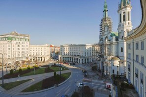 A stunning cityscape view of historic architecture, including a grand church and surrounding buildings bathed in sunlight.

