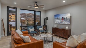 Cozy living room with gas fireplace and main level deck access