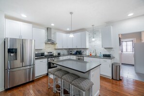 A fully updated kitchen with stainless steel appliances. 