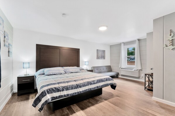 The centerpiece of the room is a king-sized bed adorned with crisp linens.