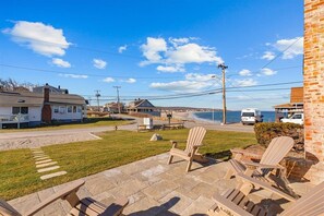 This patio now furnished with sofa, swivel chairs and fire pit