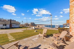 This patio now furnished with sofa, swivel chairs and fire pit